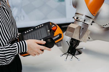 Person controls a robot. 